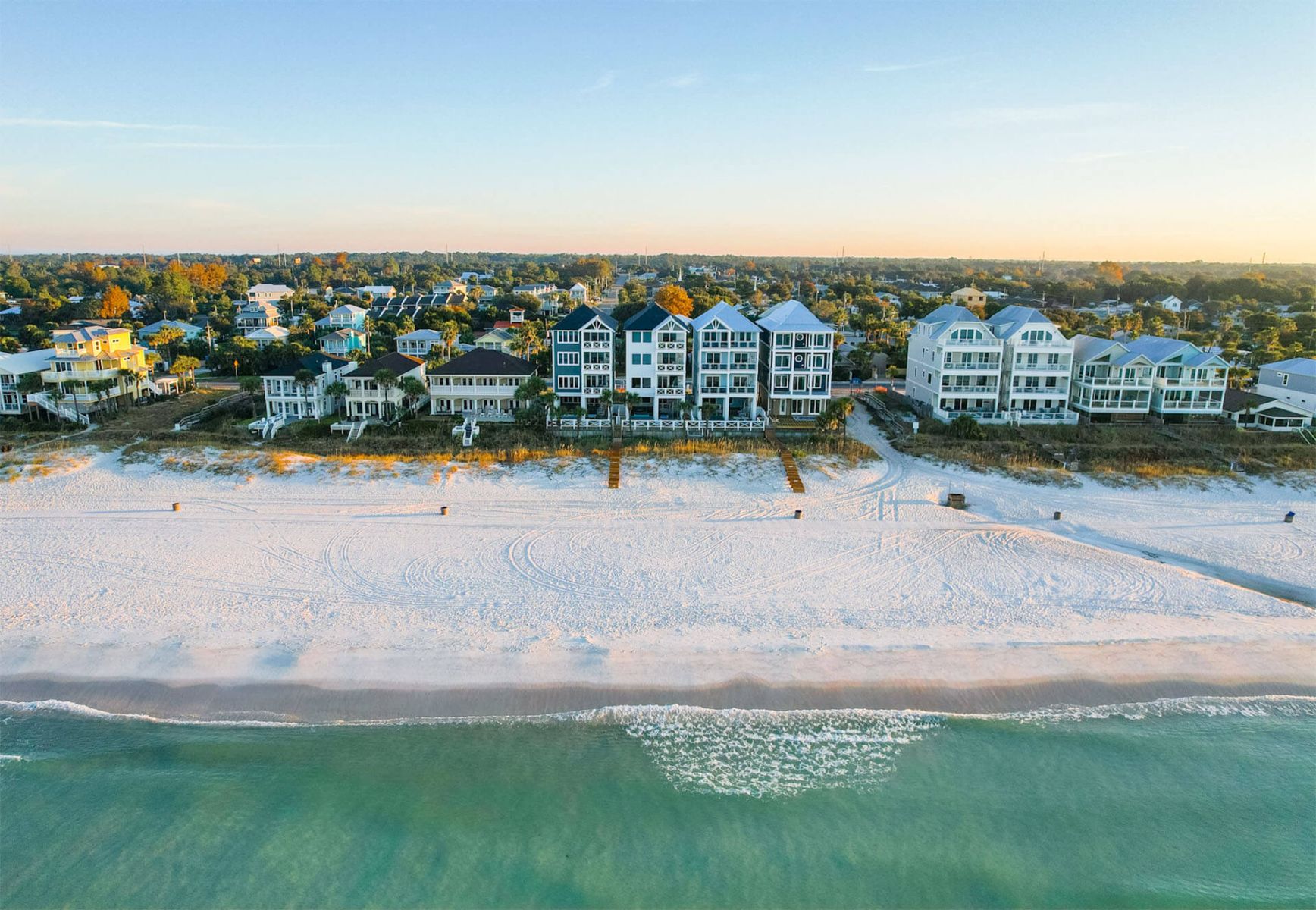 Coastal homes beside the white sand and Gulf waters of Panama City Beach